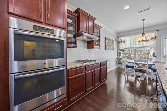 a bathroom with a granite countertop sink toilet and a shower