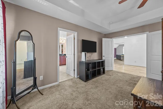 a bathroom with a granite countertop double vanity sink a mirror and a bathtub