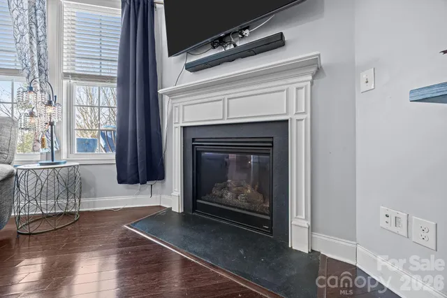 a kitchen with stainless steel appliances a dining table chairs and wooden floor