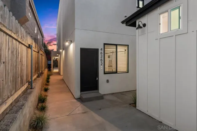 a view of a hallway with wooden walls and stairs