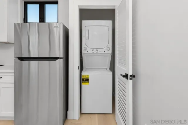 a refrigerator freezer and a stove sitting inside of a kitchen