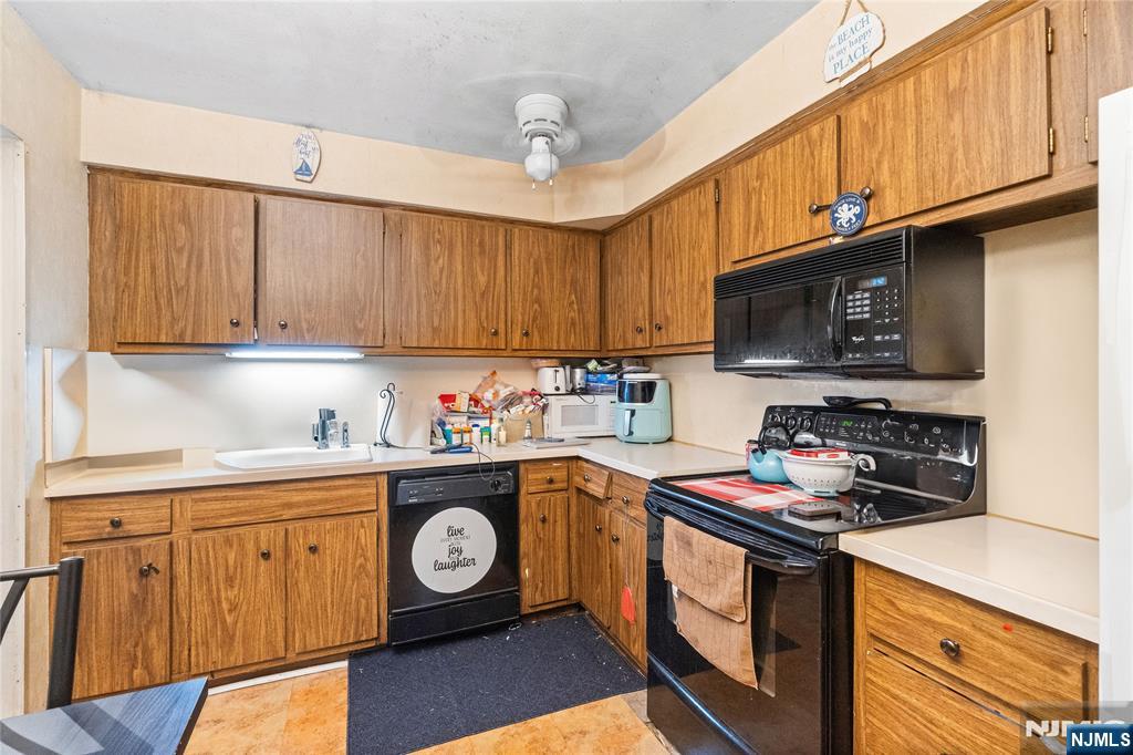 468 A Liberty Street, Unit 101 Little Ferry, NJ 07643 - Photo 11 of 22 a kitchen with stainless steel appliances granite countertop a stove top oven a sink dishwasher and cabinets with wooden floor