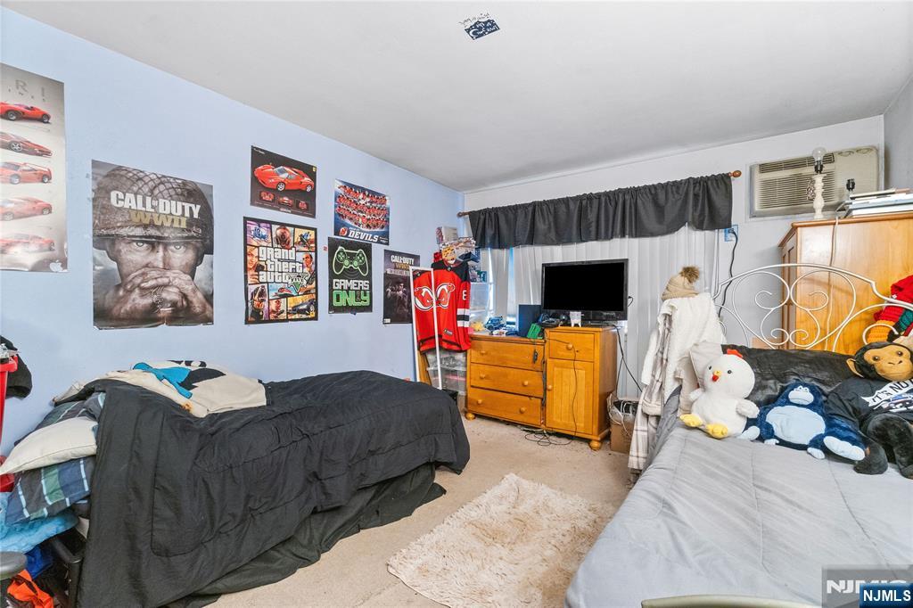 468 A Liberty Street, Unit 101 Little Ferry, NJ 07643 - Photo 17 of 22 a bedroom with furniture and a flat screen tv