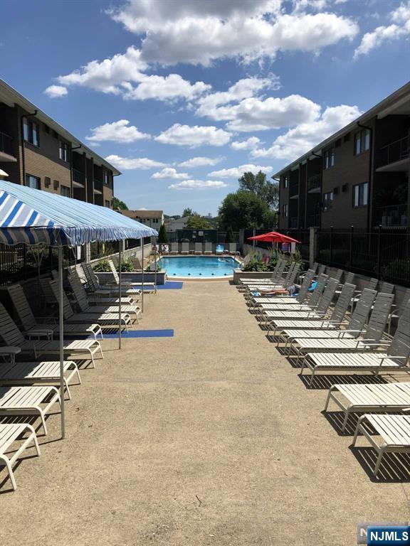 468 A Liberty Street, Unit 101 Little Ferry, NJ 07643 - Photo 22 of 22 a view of a swimming pool with a patio and a yard