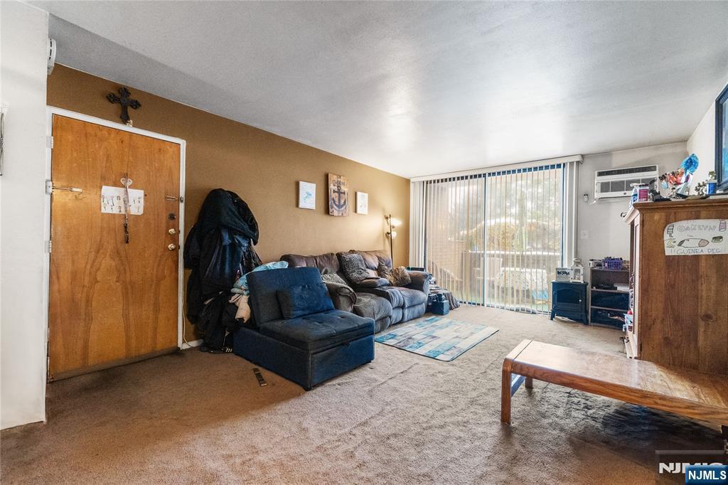 468 A Liberty Street, Unit 101 Little Ferry, NJ 07643 - Photo 5 of 22 a living room with furniture a lamp and a window