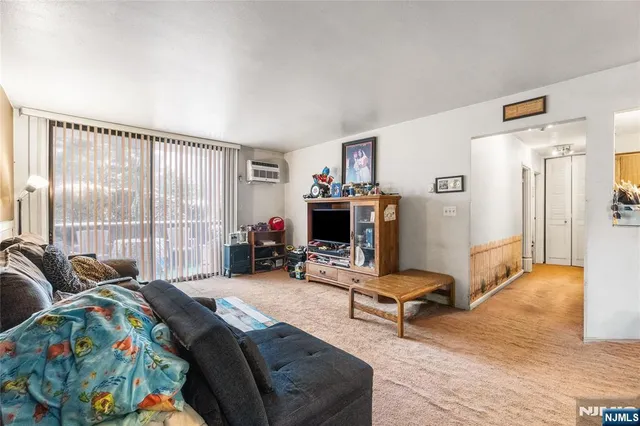 a bedroom with furniture and a large window