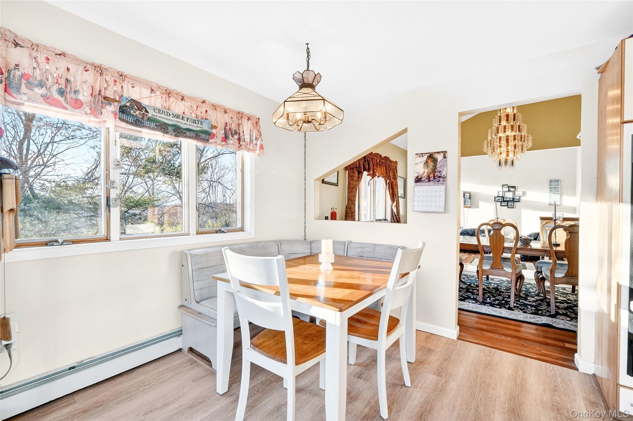 254 Orrs Mills Road Cornwall, NY 12553 - Photo 16 of 50 a view of a dining room with furniture wooden floor and a chandelier