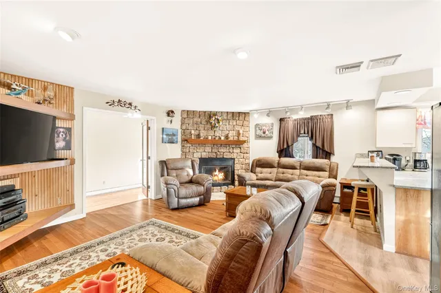 a dining room with furniture a rug and wooden floor