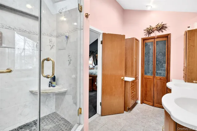 a bedroom with a bed a mirror and dresser