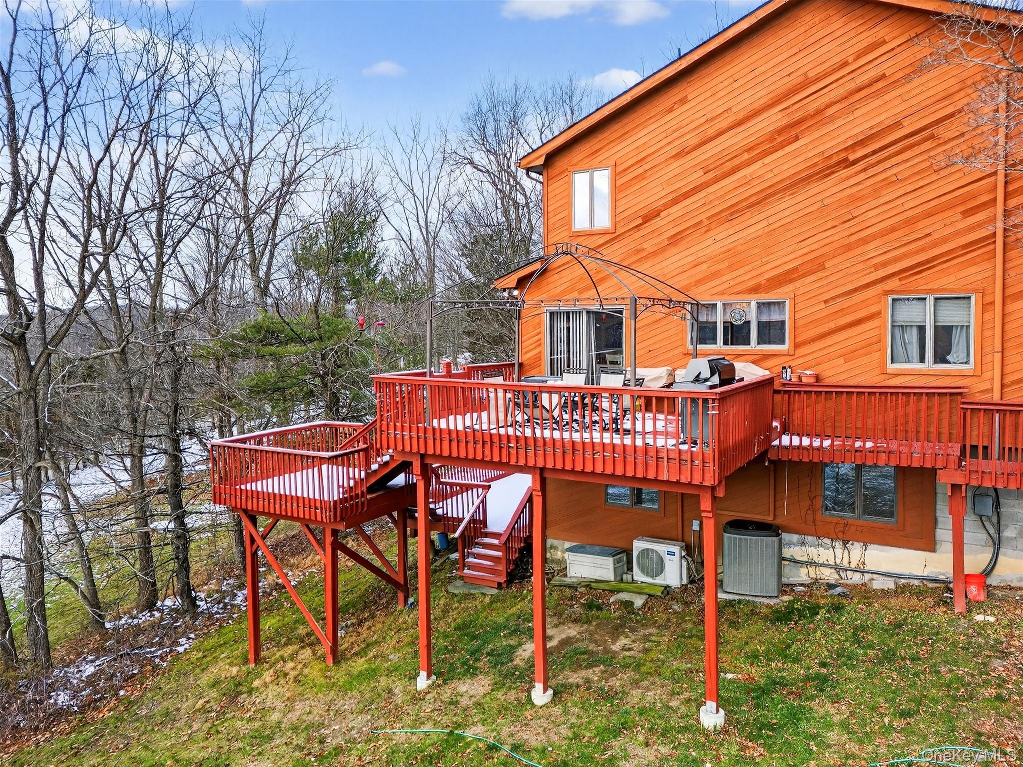 254 Orrs Mills Road Cornwall, NY 12553 - Photo 42 of 50 a roof deck with table and chairs under an umbrella