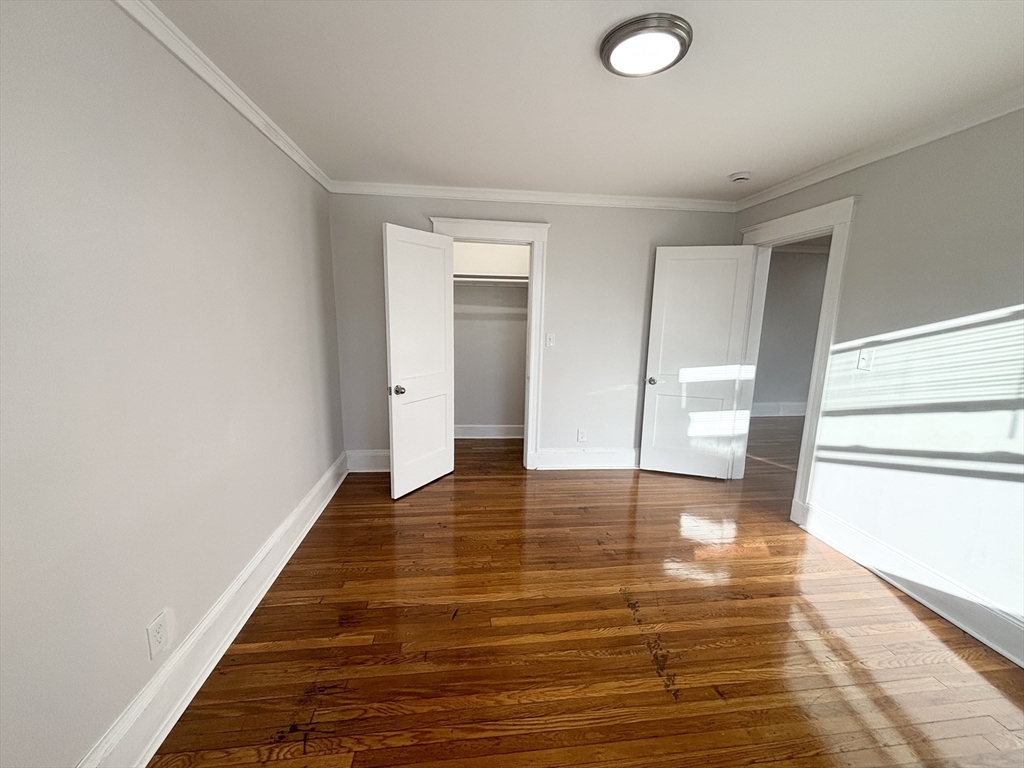 36 Spring Street, Unit 11 Malden, MA 02148 - Photo 10 of 12 a view of empty room with wooden floor