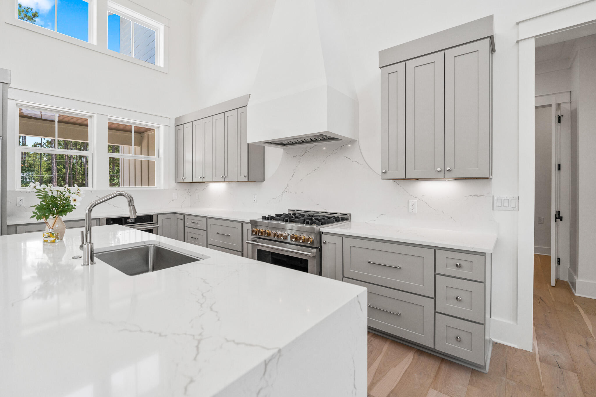 121 West Nursery Road Santa Rosa Beach, FL 32459 - Photo 21 of 66 a kitchen with granite countertop a sink dishwasher stove and cabinets