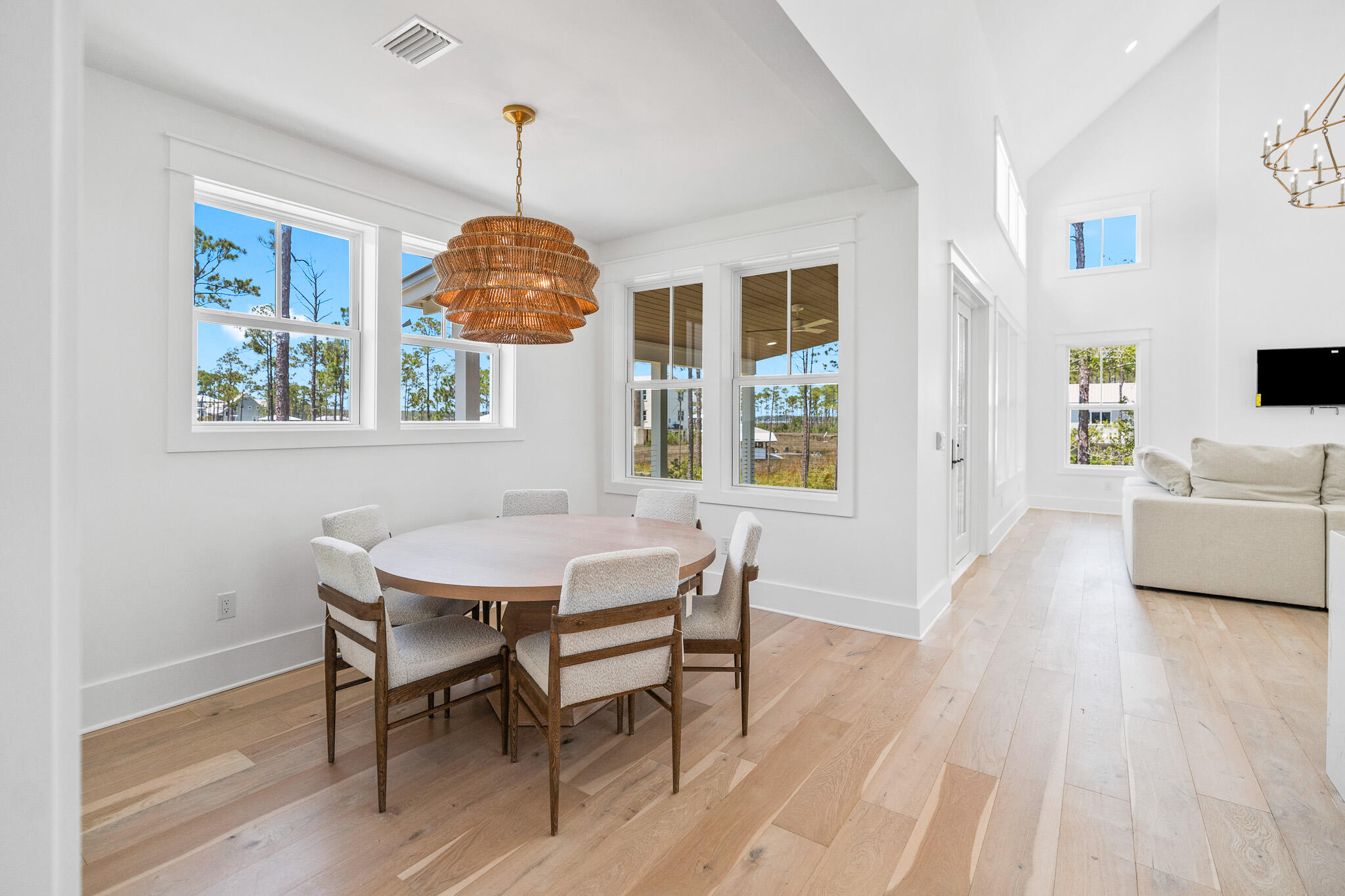 121 West Nursery Road Santa Rosa Beach, FL 32459 - Photo 32 of 66 a view of a dining room with furniture wooden floor and a chandelier