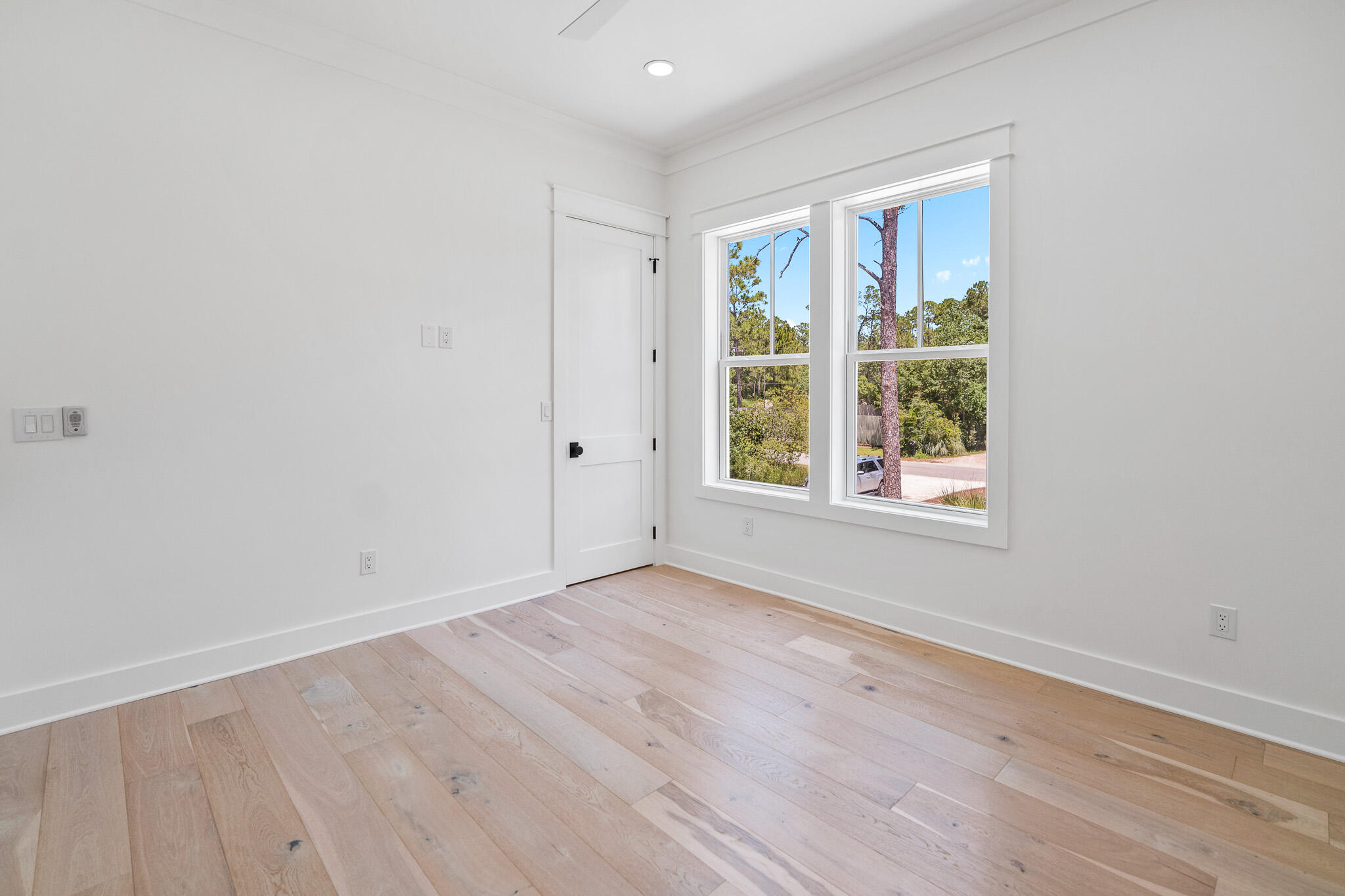 121 West Nursery Road Santa Rosa Beach, FL 32459 - Photo 43 of 66 an empty room with wooden floor and windows