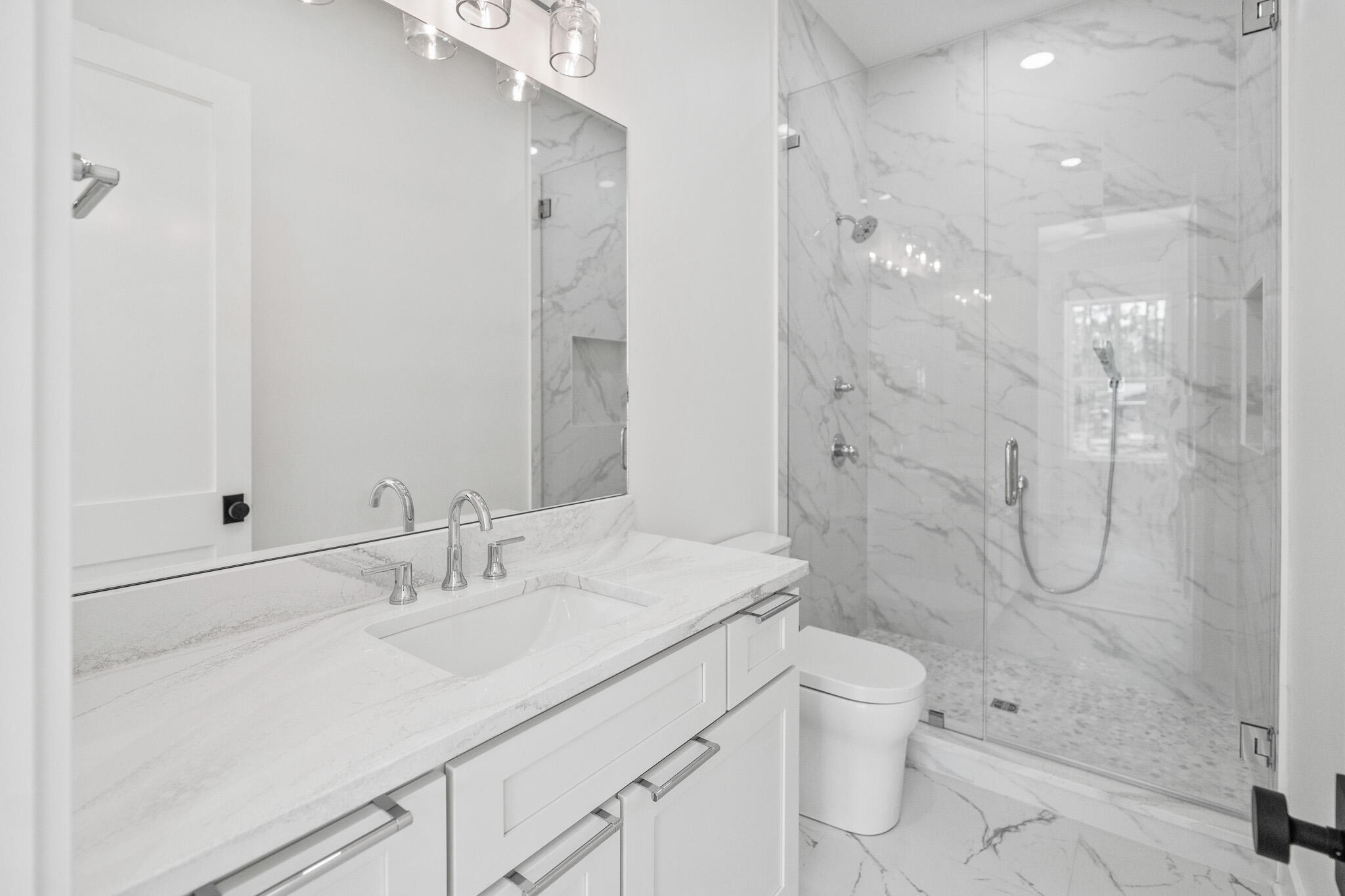 121 West Nursery Road Santa Rosa Beach, FL 32459 - Photo 45 of 66 a bathroom with a shower sink vanity mirror and toilet