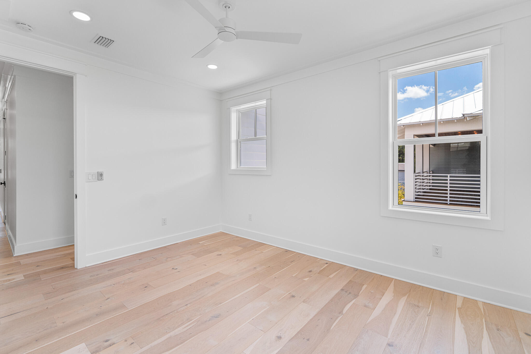 121 West Nursery Road Santa Rosa Beach, FL 32459 - Photo 56 of 66 an empty room with wooden floor and windows
