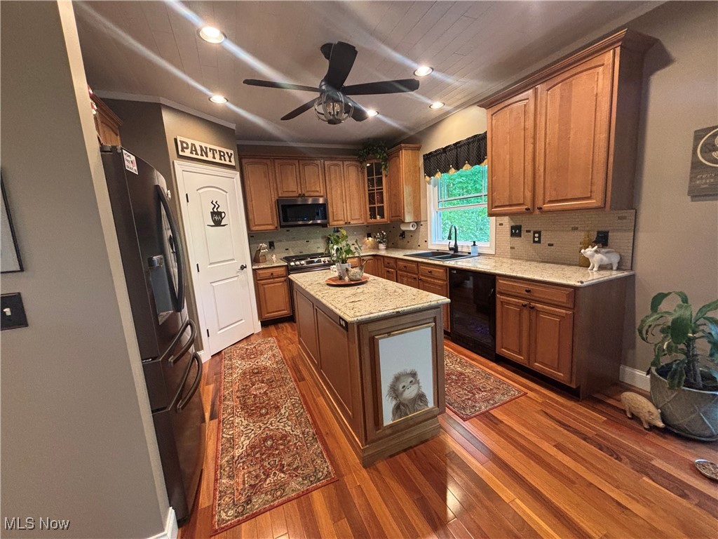 5232 Emerson Road Madison, OH 44057 - Photo 5 of 48 Kitchen featuring recessed lighting, tasteful backsplash, black appliances, dark wood-style flooring, and glass insert cabinets