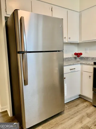 a white refrigerator freezer sitting in a kitchen
