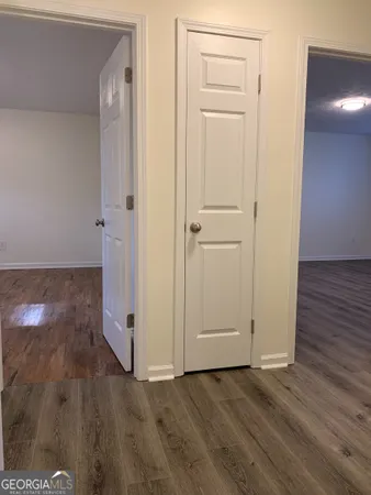 an empty room with wooden floor and closet