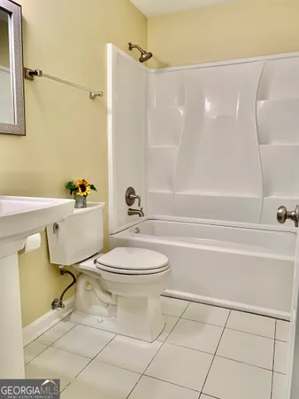 a bathroom with a toilet and a bath tub