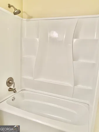 a bathroom with a shower and a bath tub