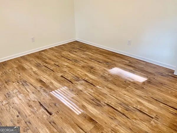 a view of a room with wooden floor