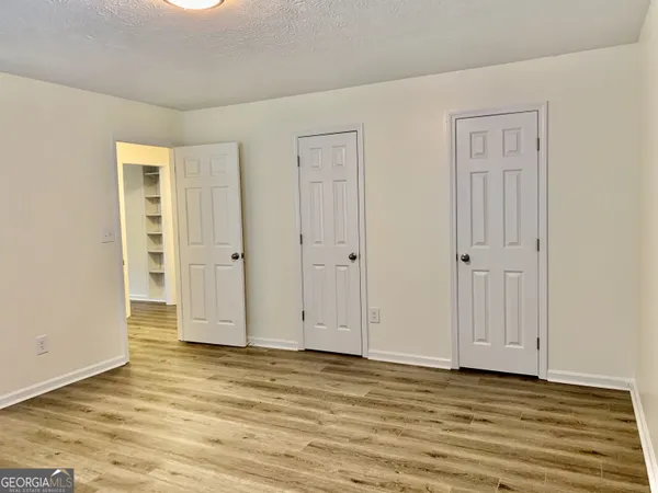 a view of wooden floor and closet area