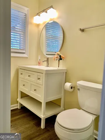 a bathroom with a toilet a sink and a mirror