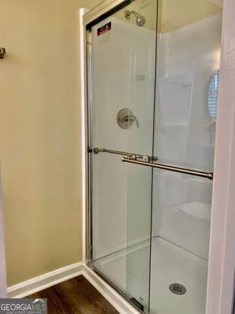 a bathroom with a glass shower door