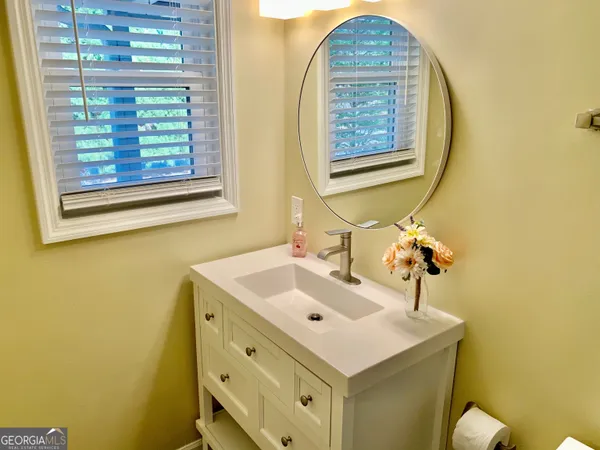 a bathroom with a sink and a mirror