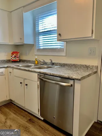 a kitchen with granite countertop cabinets sink and window