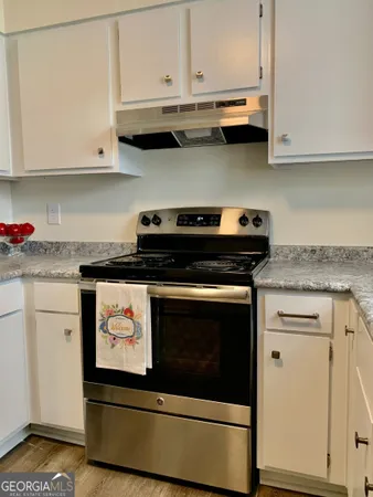 a stove top oven sitting inside of a kitchen