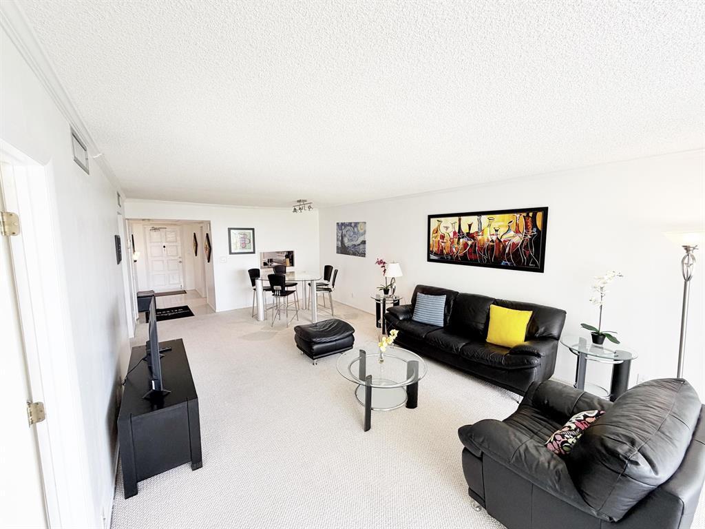 2681 South Course Drive, Unit 511 Pompano Beach, FL 33069 - Photo 12 of 35 a living room with furniture and a flat screen tv