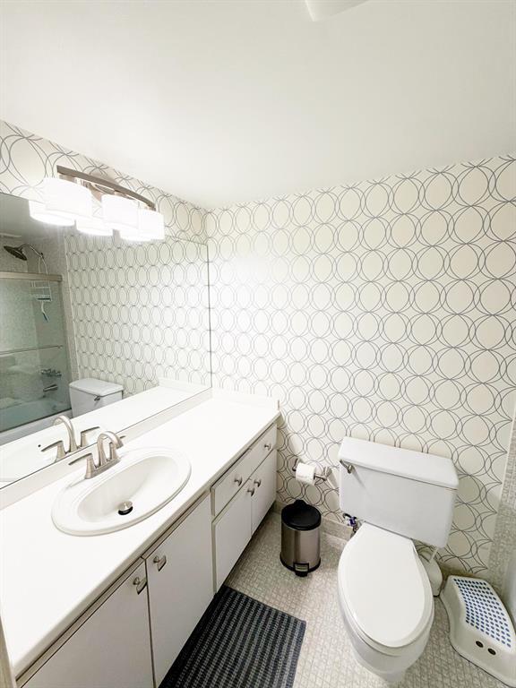 2681 South Course Drive, Unit 511 Pompano Beach, FL 33069 - Photo 13 of 35 a bathroom with a sink mirror vanity and toilet