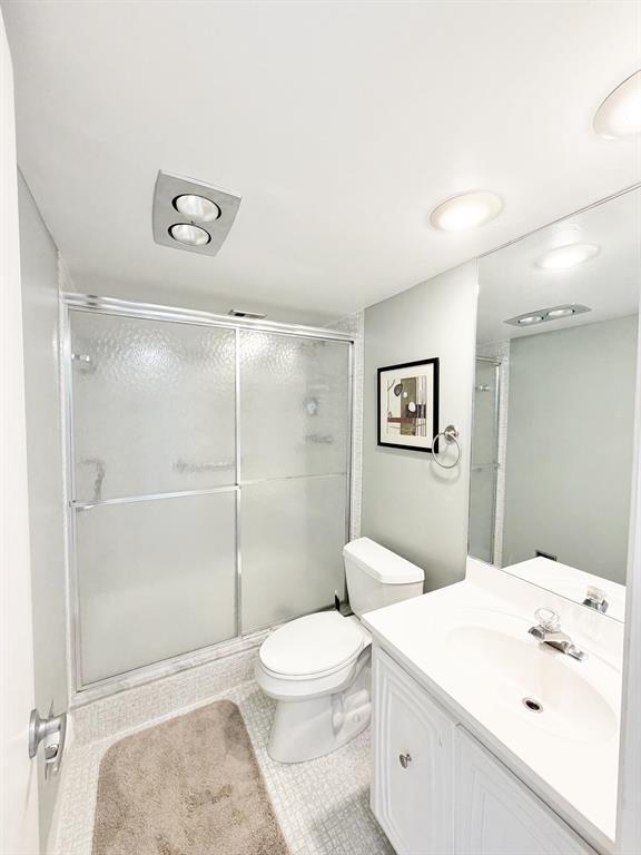 2681 South Course Drive, Unit 511 Pompano Beach, FL 33069 - Photo 22 of 35 a white toilet sitting next to a bathroom sink