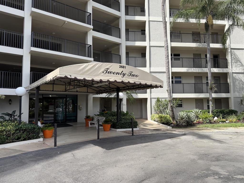 2681 South Course Drive, Unit 511 Pompano Beach, FL 33069 - Photo 3 of 35 a view of a building with a potted plant and a window