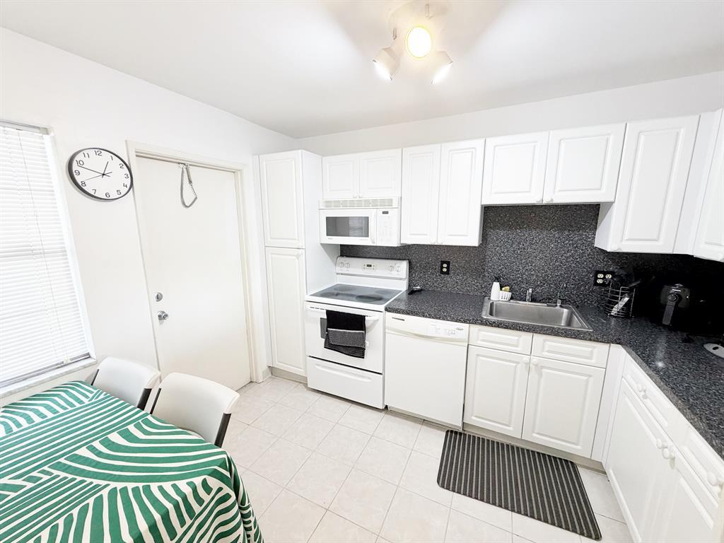 2681 South Course Drive, Unit 511 Pompano Beach, FL 33069 - Photo 5 of 35 a kitchen with a cabinets and appliances