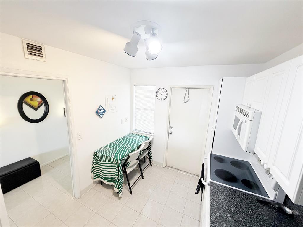 2681 South Course Drive, Unit 511 Pompano Beach, FL 33069 - Photo 7 of 35 a room with a couch and a chandelier