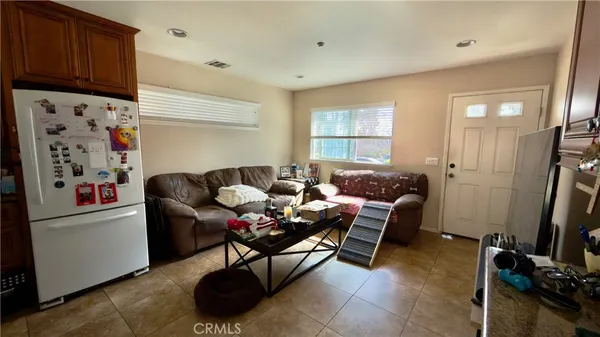 a living room with furniture a flat screen tv and a window