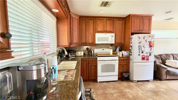 a kitchen with stainless steel appliances a stove a sink a refrigerator and cabinets