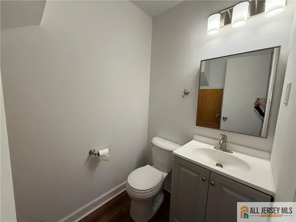 a bathroom with a toilet sink and mirror