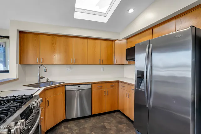 a kitchen with a refrigerator and a sink