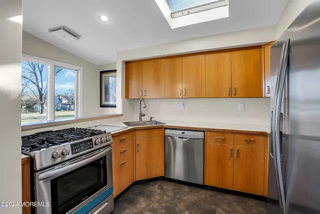 a kitchen with a stove a sink and a microwave