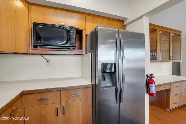 a kitchen with a refrigerator and microwave