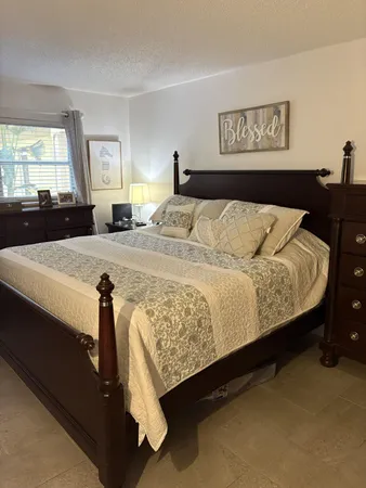 a bedroom with a bed and window