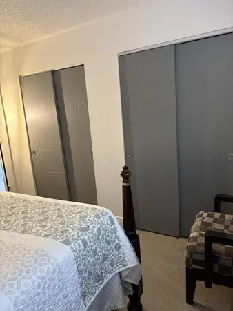 a bedroom with a bed and a mirror