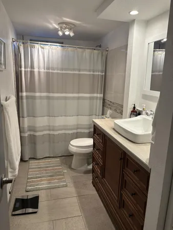 a bathroom with a sink a toilet and a mirror