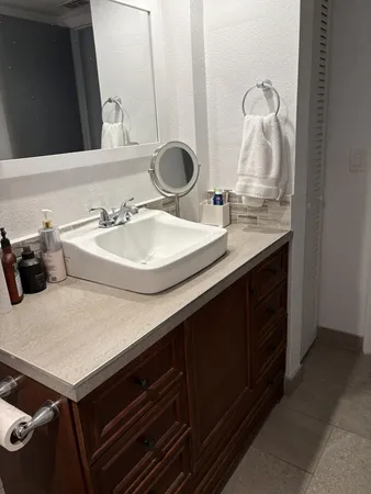 a bathroom with a sink and a mirror