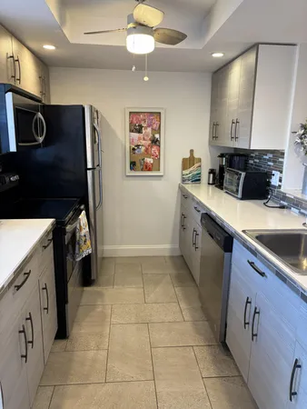a kitchen with a sink and a stove top oven