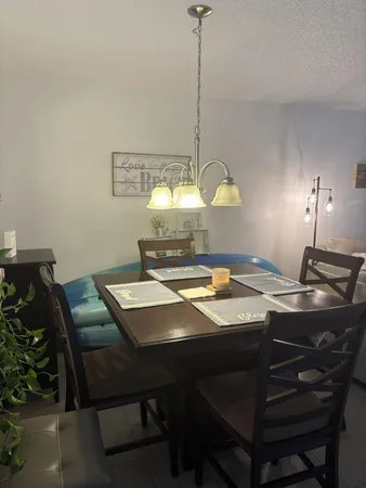 a view of a dining room with a table and chairs